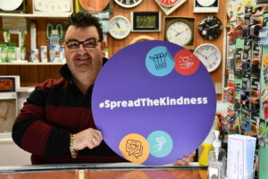 Market Trader With #Lookingoutforeachother and #Spreadthekindness signs